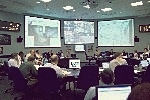 Aug. 4 (Flight Day 10), the Mission Management Team, meeting in a conference room at the Houston's Mission Control Center, gives the 