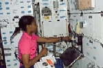 STS-121 mission specialist, Stephanie D. Wilson, works with equipment on the middeck of the Space Shuttle Discovery while docked at the ISS, on Flight Day 4