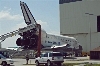thumbnail to a view of shuttle Discovery, the orbiter for the Space Shuttle STS-124 mission, having been towed to the Orbiter Processing Facility (OBS), at the Kennedy Space Center, on June 14th, 2008. Such a step is the official end for any Space Shuttle mission, with the orbiter to be processed there for another mission / vignette-lien vers une vue de la navette Discovery, la navette de la mission STS-124, aux portes du Orbiter Processing Facility, au Kennedy Space Center, le 14 juin 2008. L'arrive de la navette  ce btiment marque la fin officielle de la mission. Elle y sera re-prpare pour une future mission