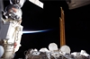 thumbnail to a view of a docked Russian Soyuz spacecraft (left), a portion of the ISS Quest airlock and solar array panels as seen during the STS-133 mission / vignette-lien vers une vue de l'ISS pendant la mission STS-133: un Soyouz russe  gauche, une partie du Quest Airlock et des panneaux solaires