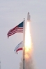 thumbnail to a view of Space shuttle Atlantis soaring past the American flag after lifting off Launch Pad 39A at NASA's Kennedy Space Center in Florida at 11:29 a.m. (EDT) on July 8, 2011, aboard the last flight of the Space Shuttle program / vignette-lien vers une vue de la navette Atlantis qui dcolle du pas de tir 39A du Kennedy Space Center, en Floride,  11h 29 heure d't de la cte est amricaine le 8 juillet 2011. Il s'agit du dernier vol de la navette spatiale
