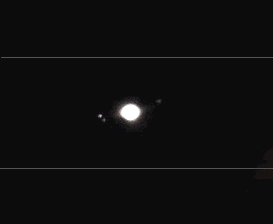 Jupiter (overexposition not wanted) and its satellites; Io is missing as it is transiting in front of the gas giant (114mm refractor with a magnifiying power of 45x and a handheld Nikon S3100 compact digital camera; home observatory)