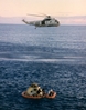 thumbnail to a view of Apollo 10 astronauts being helped out of the CM by Navy recovery swimmers while a helicopter hovers ready to hoist them aboard