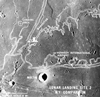 thumbnail to a view of a photographic illustration comparing the size of Apollo 11 Landing Site 2 with that of the metropolitan New York City area. The white overlay is printed over a lunar surface photograph taken from Apollo 10 during its lunar orbit mission