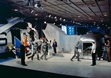 thumbnail to a view of the Apollo 11 astronauts walk from the recovery helicopter to the MQF in the USS Hornets hangar 
bay as a portion of the backup MQF is visible behind the prime