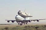 Shuttle Discovery on top NASA's Boeing 747 Shuttle Carrier Aircraft taking off from one leg of its three-stop, cross-country ferry flight (Aug. 19, 2005), homing to KSC