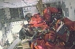 A part of the crew of the Return to Flight Mission, July 26th, 2005, is seen buckled on the seats in Space Shuttle's mid-deck